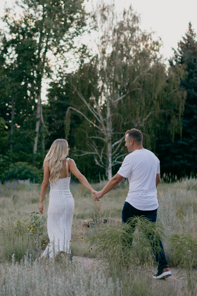 Couple walking through Denver Botanic Gardens for engagement photos