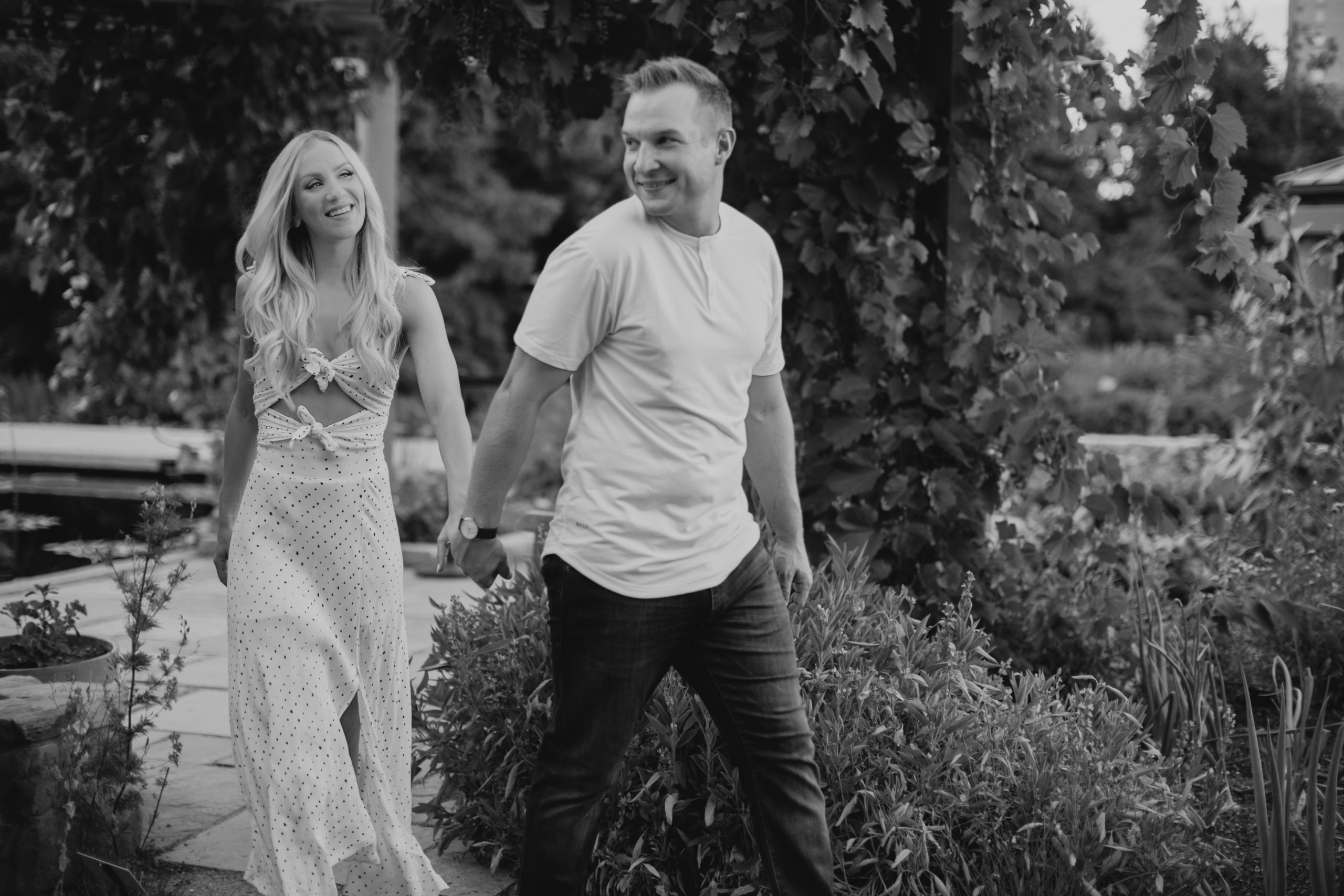 Couple walking hand in hand during Denver engagement photography session by Denver engagement photographer Caroline Brackney