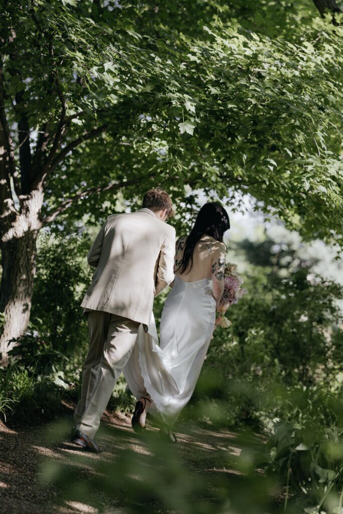 Couple at their Denver Botanic Gardens wedding walking in greenery