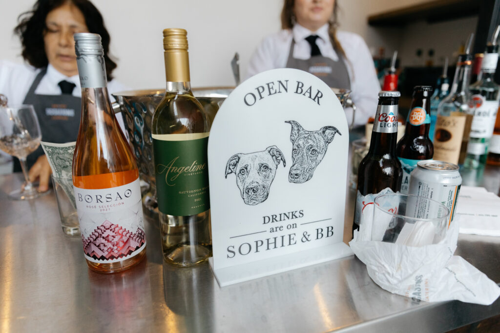 cocktail photo sign with images of 2 dogs for cocktail hour of wedding