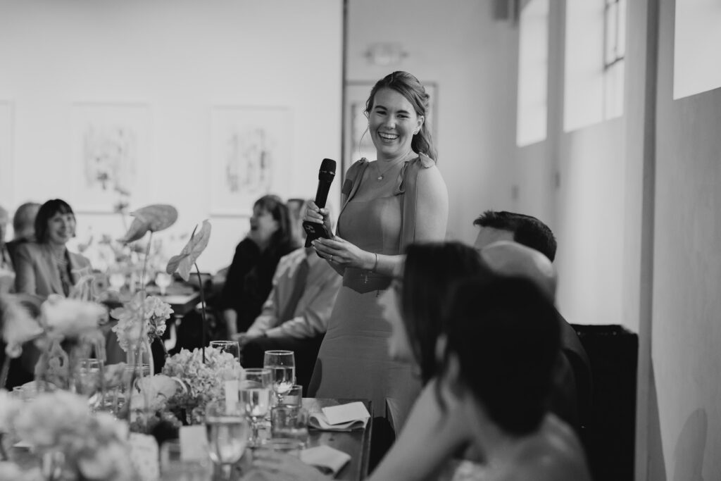 bridesmaid giving speech during wedding reception