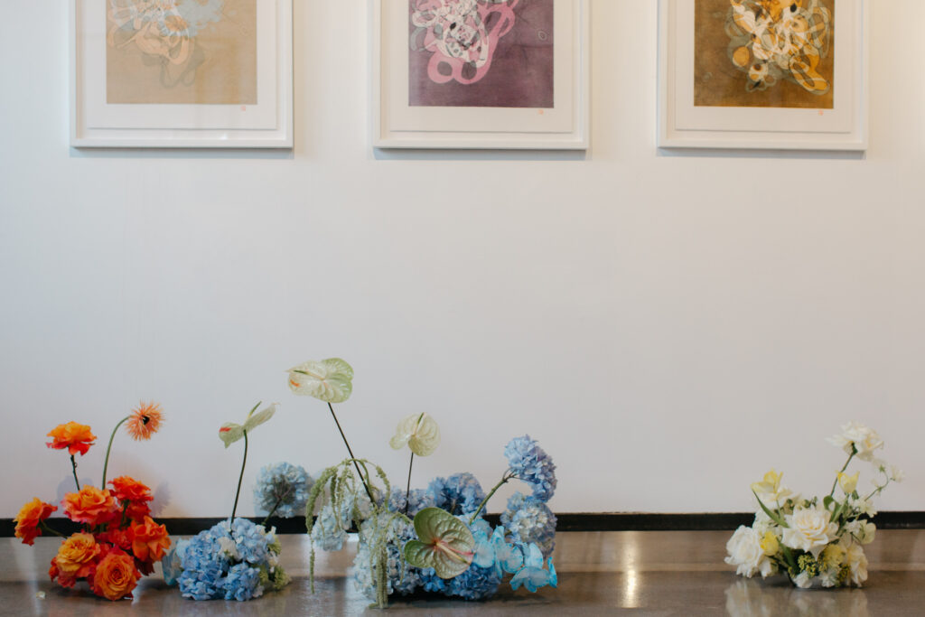 colorful floral pieces against walls lined with art