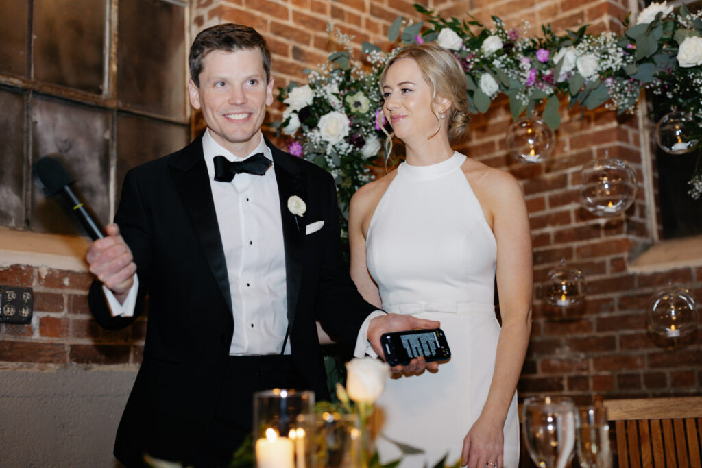 Bride and groom smiling during candid moment of Denver wedding reception at Moss venue