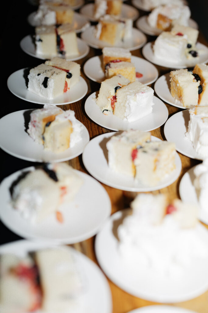 Slices of cake accentuated by direct flash from Denver wedding photographer during reception photos at Moss