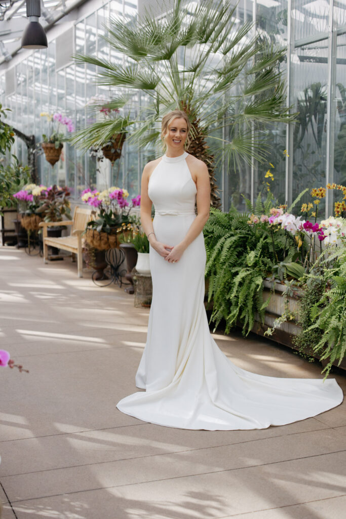 Bride standing in solarium at Denver Botanic Gardens during wedding photos for Denver wedding