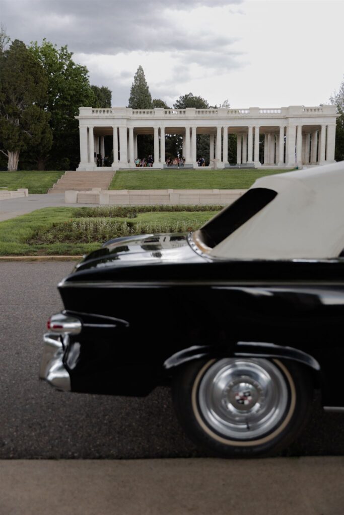 Classic car parked in front of Cheesman park pavilion during Denver wedding