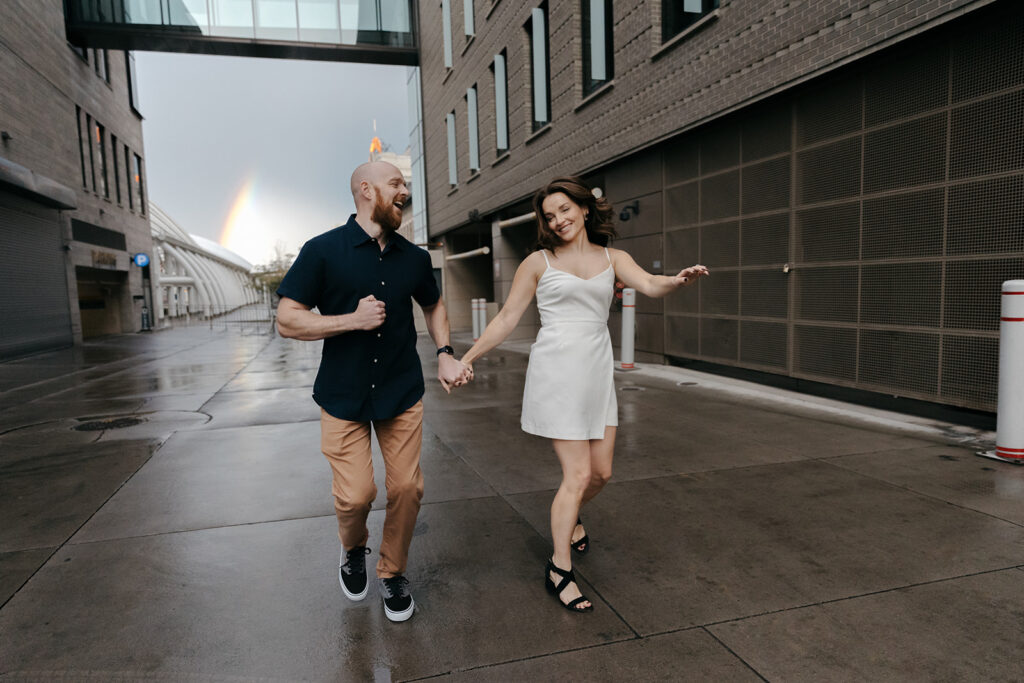 Couple frolicking around Union Station during Denver engagement photos