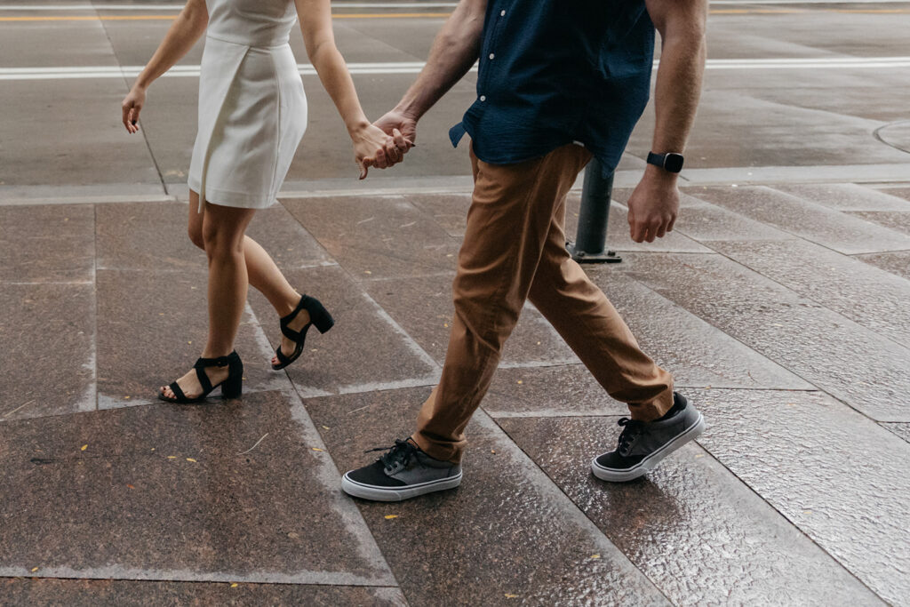 Couple walking in downtown Denver, exploring places to take engagement photos