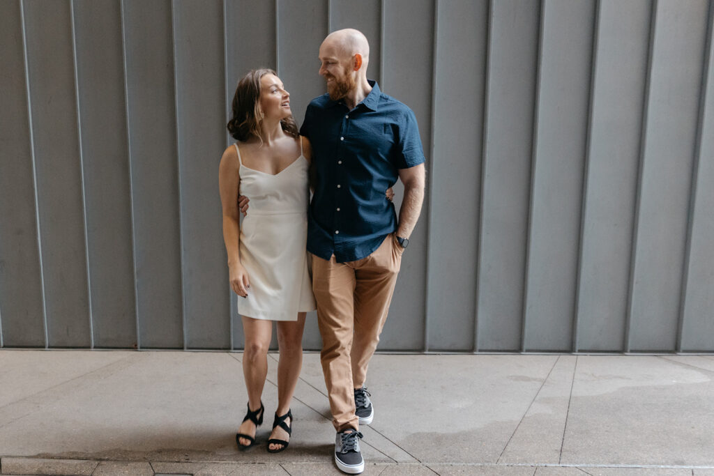 Couple stands in front of good places to take pictures in Denver for Denver engagement photos