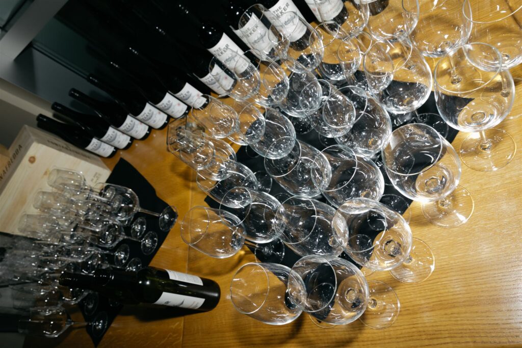 wine glasses and wine bottles sitting on wood table of Coohills restaurant during Denver wedding reception