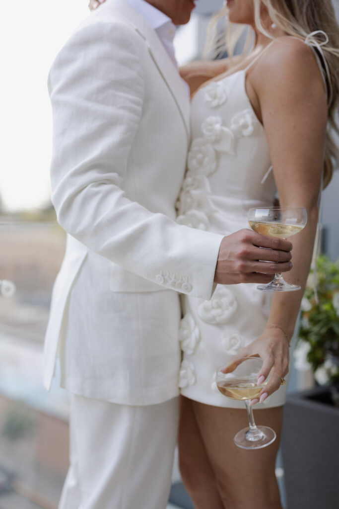 Couple holding champagne glasses during welcome party of Napa wedding