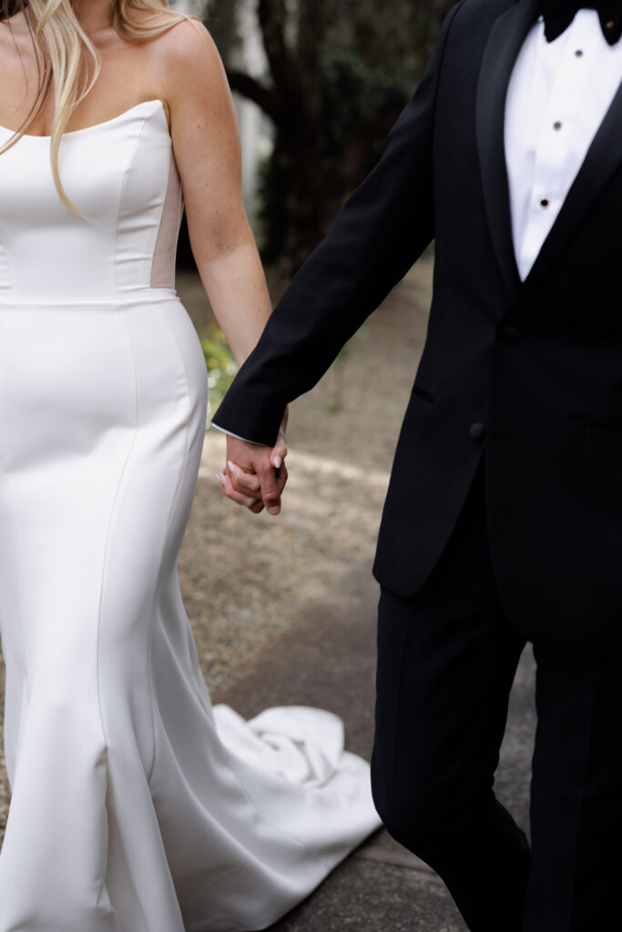 Bride and groom hold hands during wedding photos at the Estate Yountville
