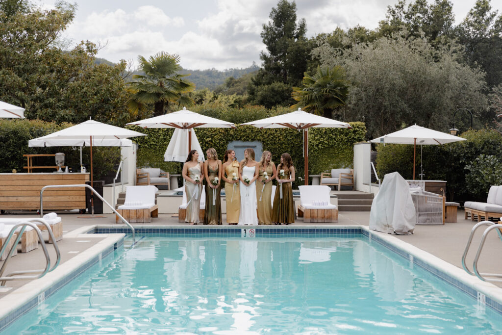 Bridesmaids standing in front of pool at the Vintage House inside the Estate Yountville