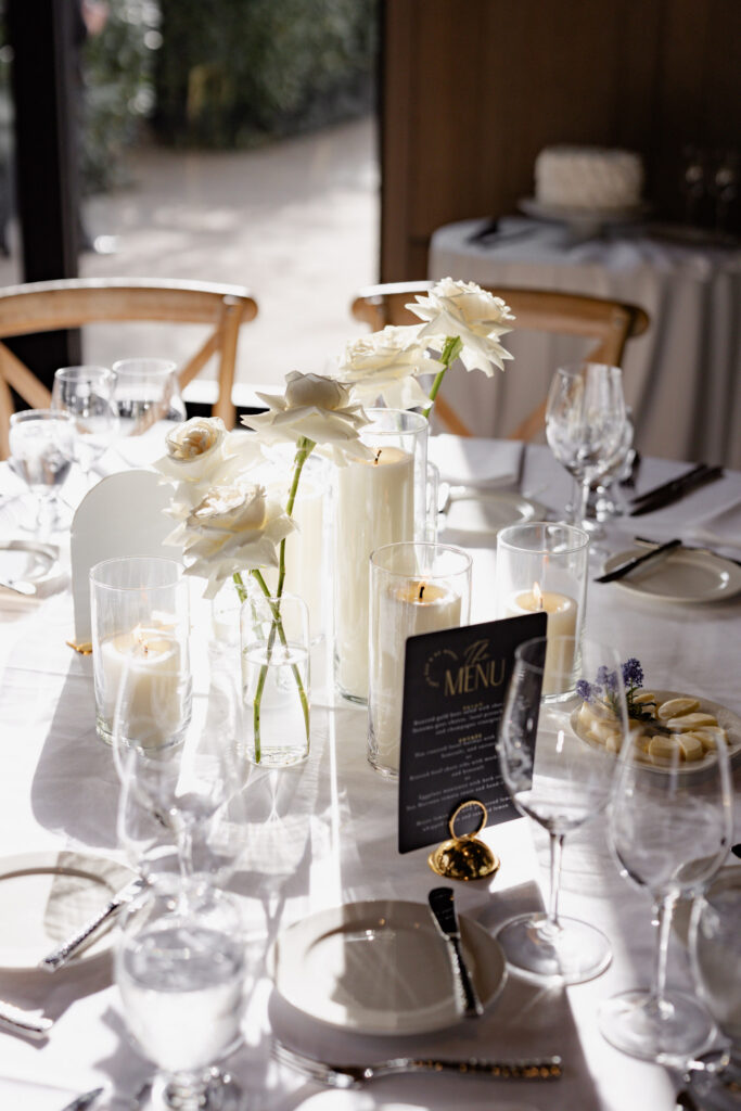 White roses sitting in sunshine on top of table during wedding at the Estate Yountville