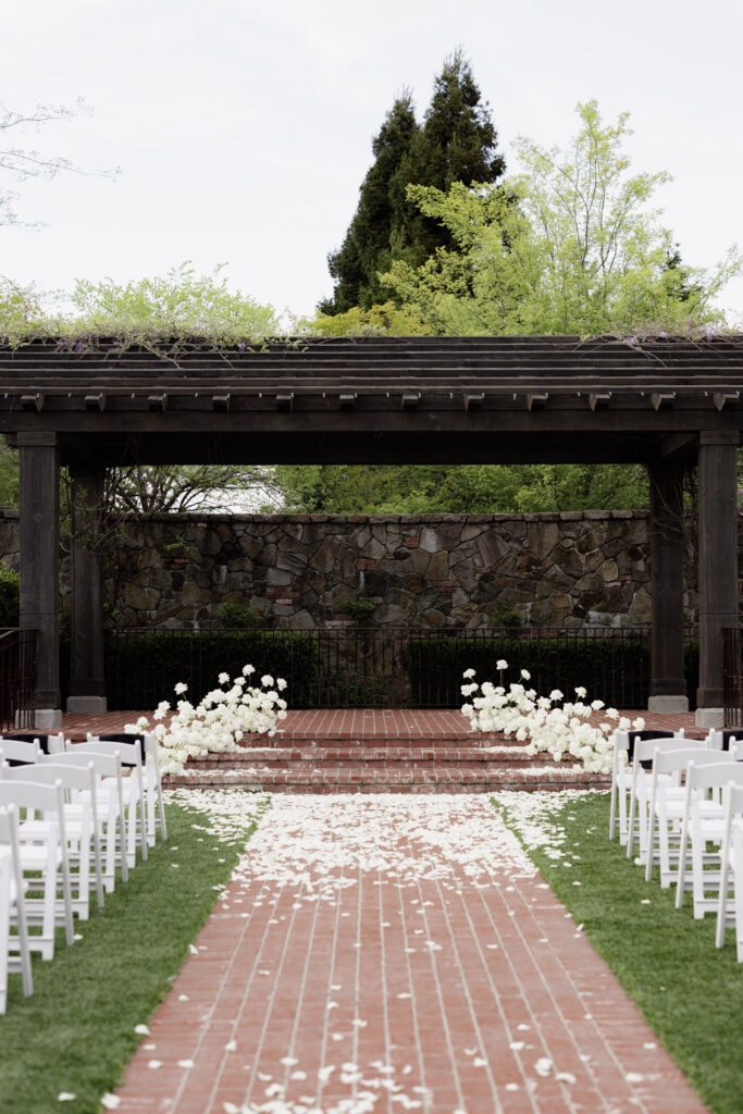 White roses scattered on pathway of the Estate Yountville for courtyard wedding