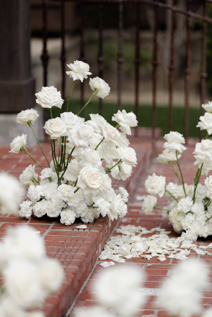White roses sit on steps of ceremony at the Estate Yountville wedding