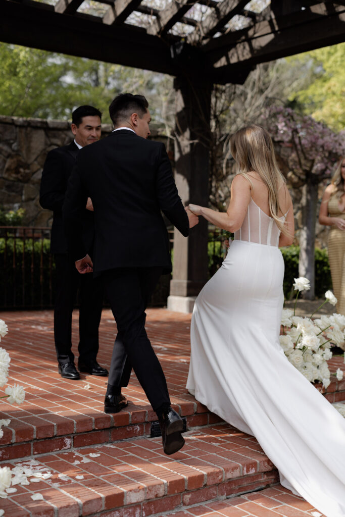 Groom taking brides hand during wedding ceremony at the Estate Yountville