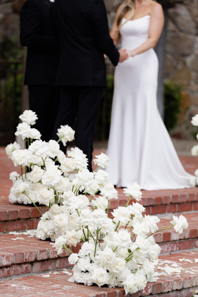 white roses on steps of wedding at the estate yountville