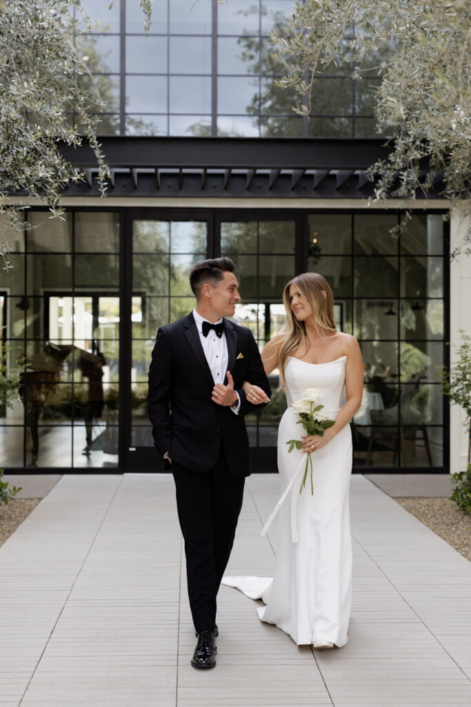 Bride and groom take candid photos in front of Vintage House at the Estate Yountville