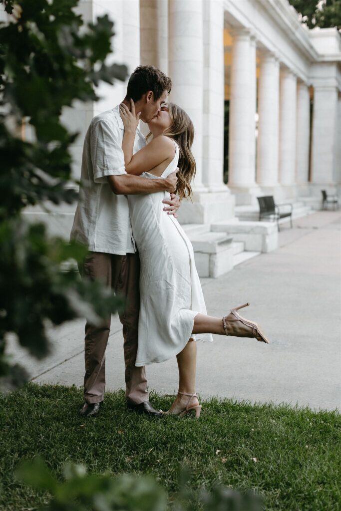 Couple embraces at Cheesman park during engagement photos