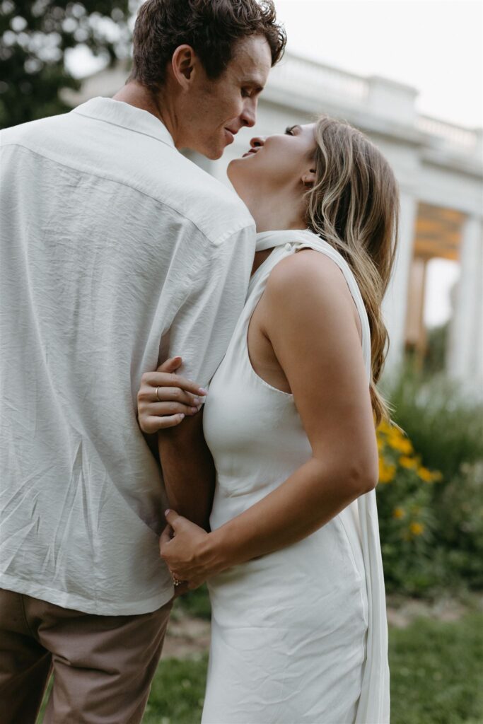 Couple embracing during engagement photos at Cheesman park