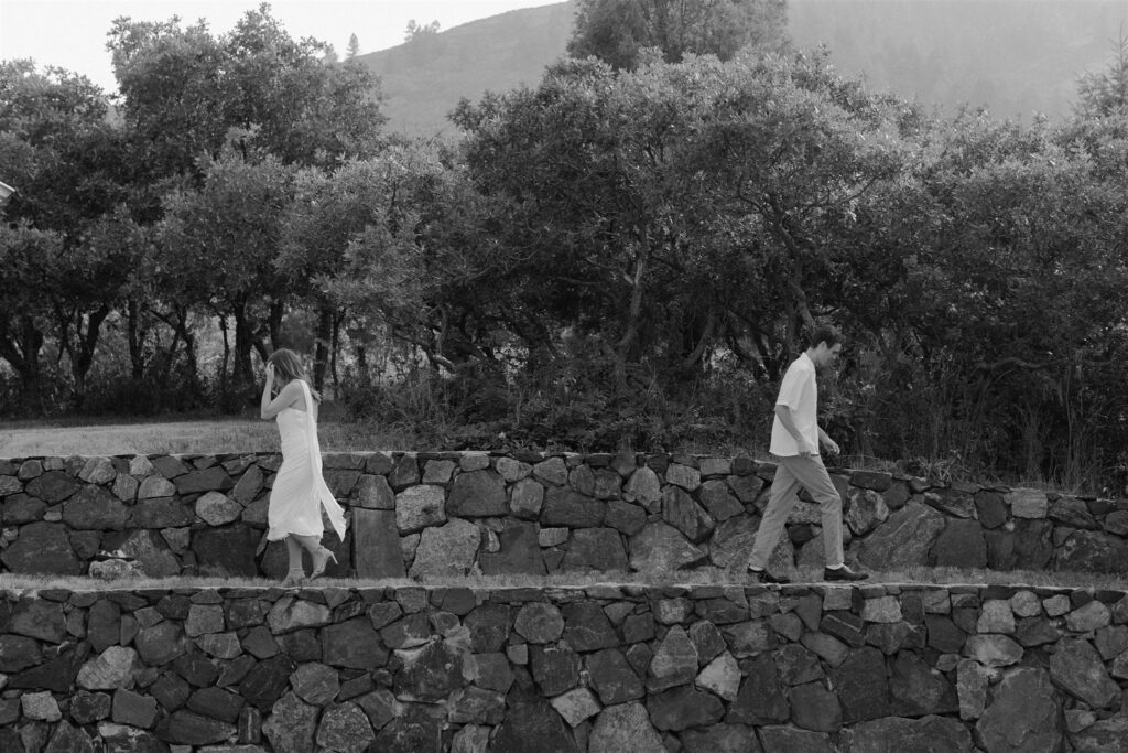 Couple walking on edge during Cheesman park engagement photos