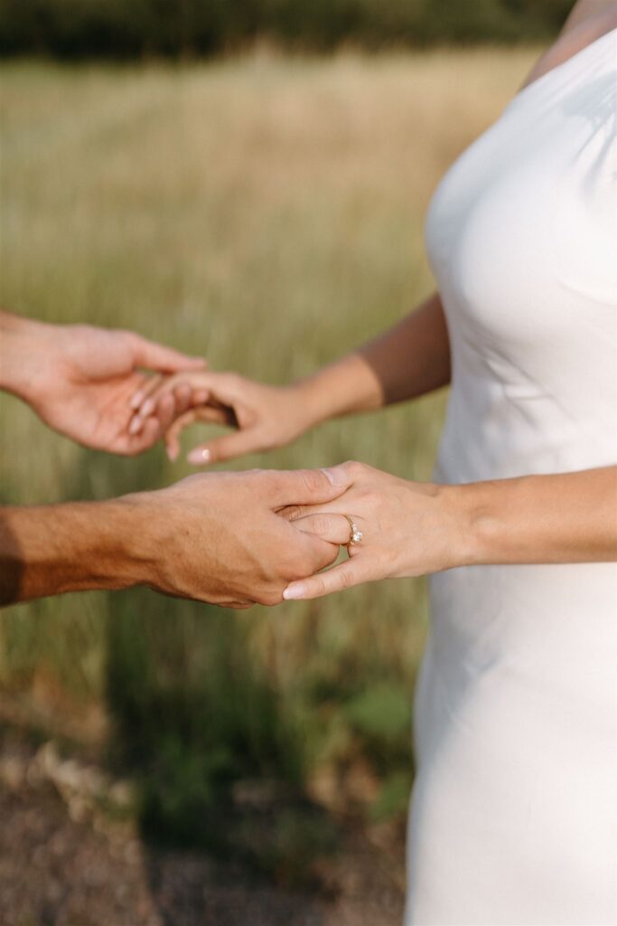 Couple holding hands during Cheesman park engagement photos