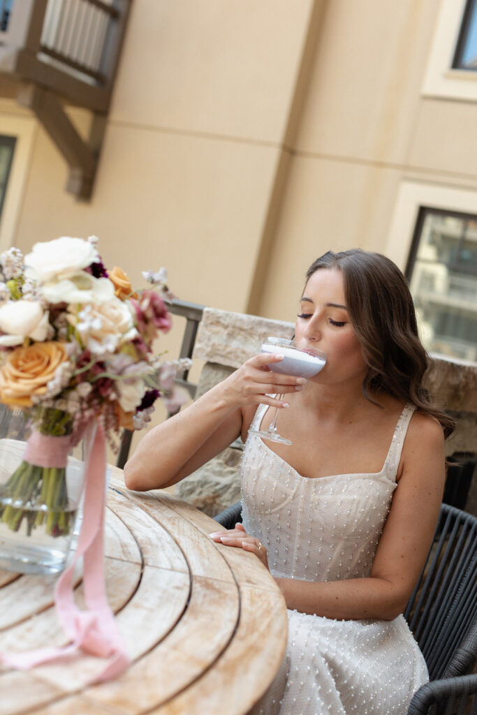 Bride sips cocktail at Four Seasons Vail