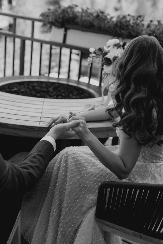 Couple holds hands during cocktails and wedding portraits at the Four Seasons Vail