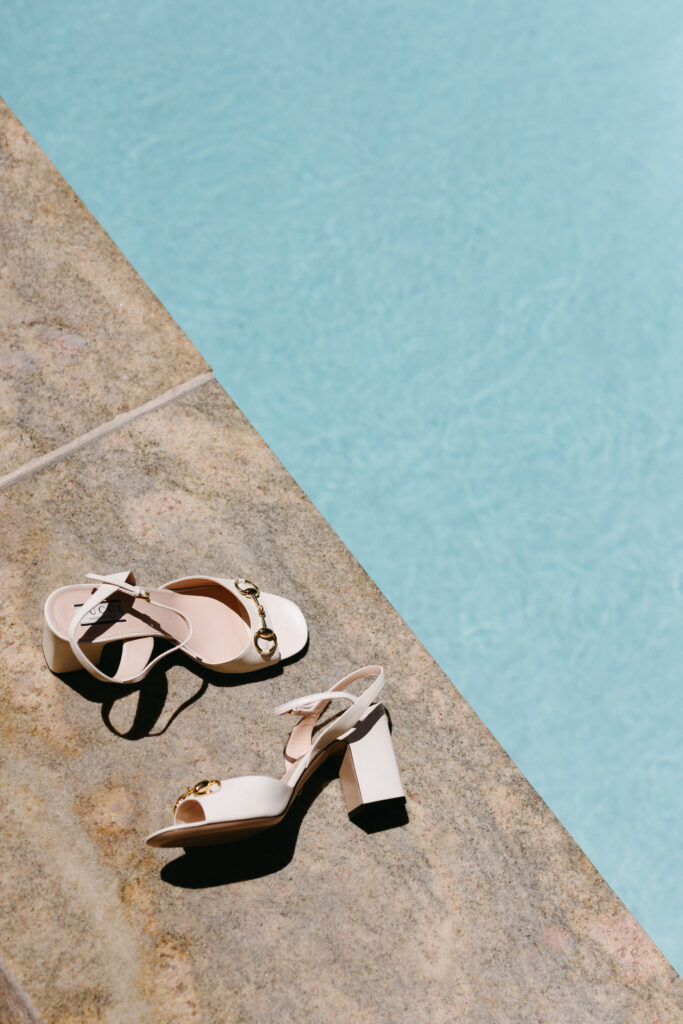 Wedding shoes sit by pool at Four Seasons Vail during elopement