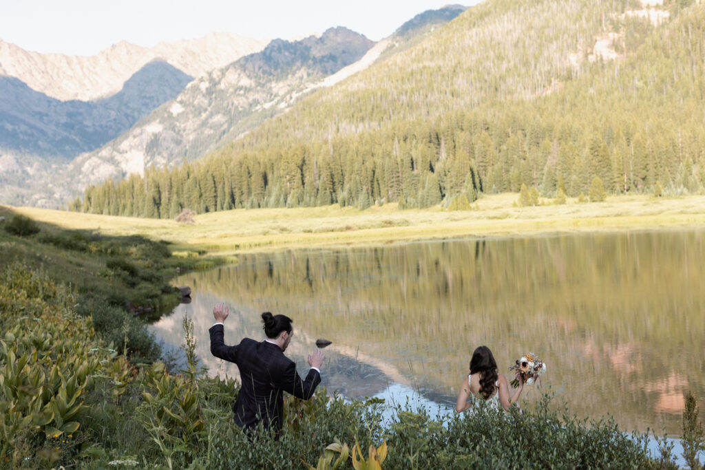 Couple walking towards lake during Piney River Ranch elopement