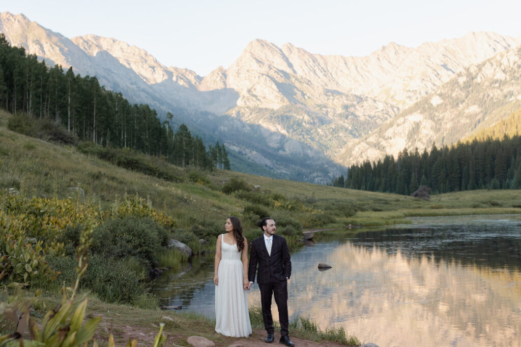 Couple holding hands looking opposite directions during elopement at Piney River Ranch