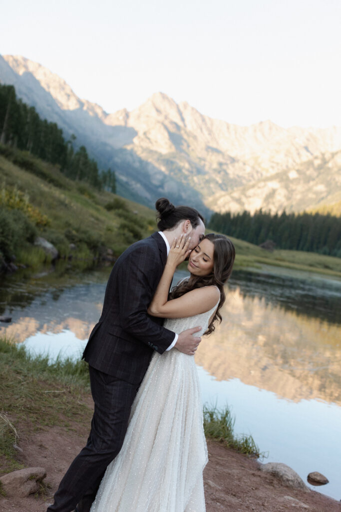 Couple embracing in front of mountains at Piney River Ranch elopement