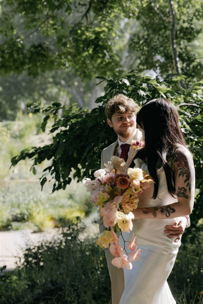 Couple embracing during Denver Botanic gardens wedding