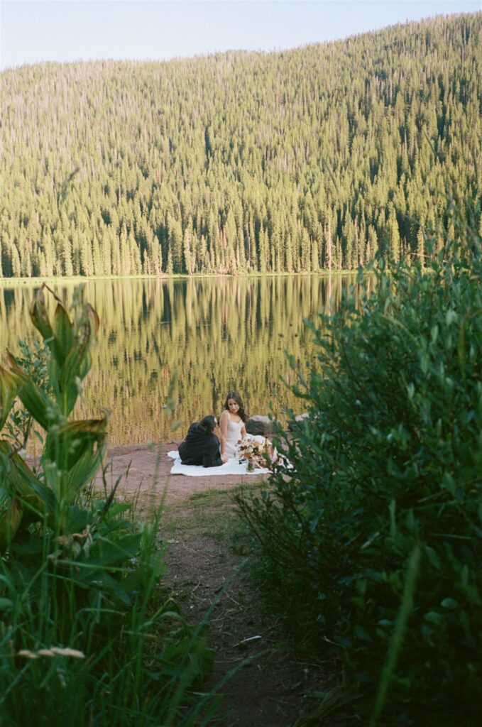 Couple enjoying picnic during elopement at Piney River Ranch