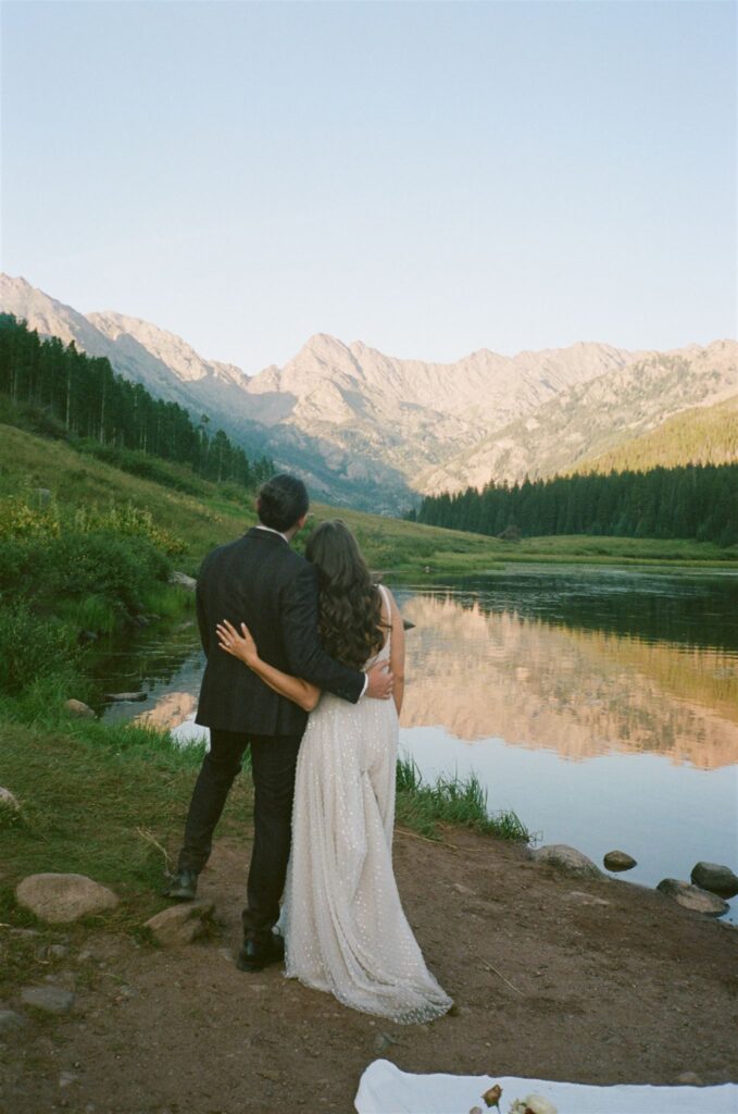 Couple watches sunset during Piney River Ranch elopement