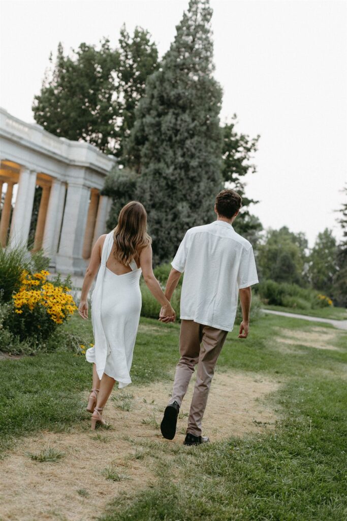 couple walking in Cheesman park for Denver engagement photos