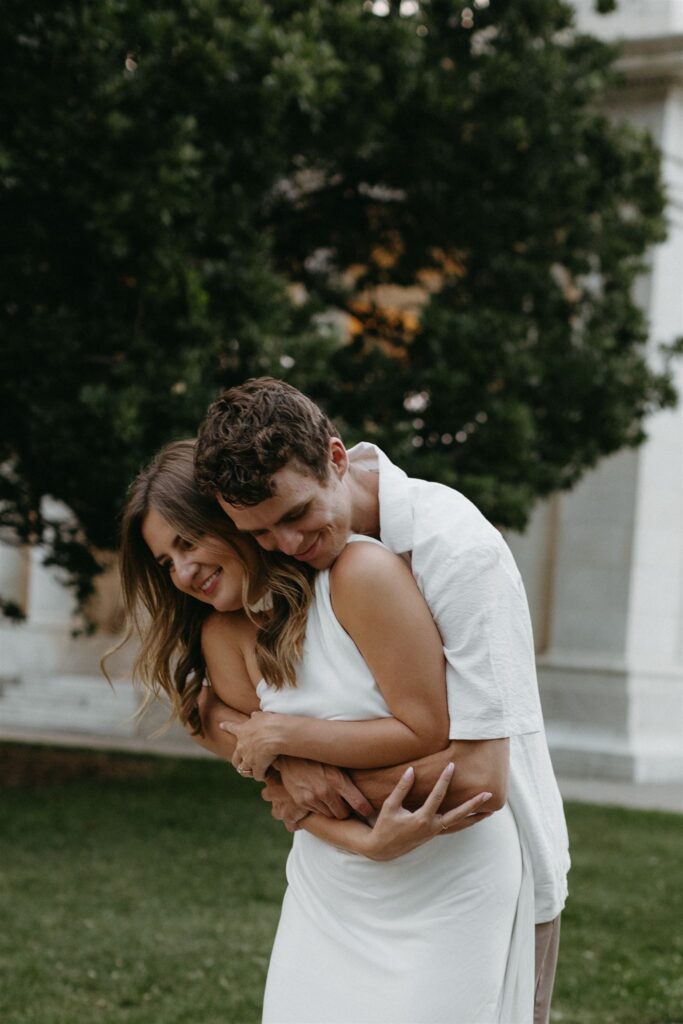 Couple taking Denver engagement photos at Cheesman Park