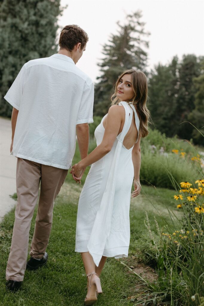 Couple walking in gardens of Cheesman park during engagement photos