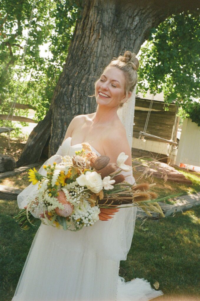 Bride smiles for wedding photography on film portraits at Colorado wedding