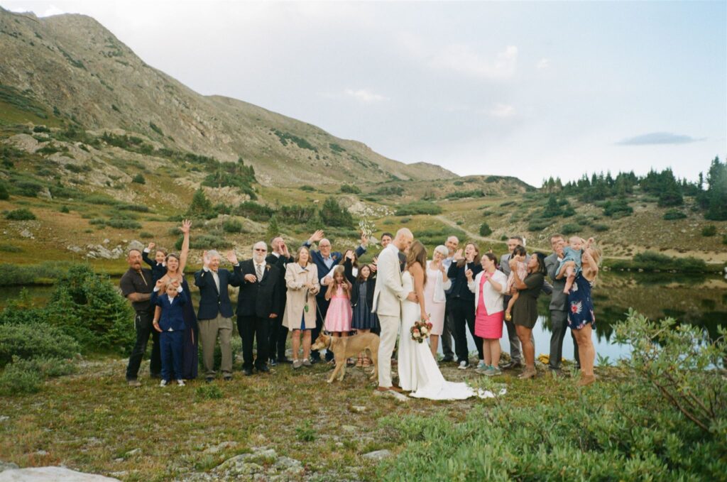 Couple and family poses for wedding photography on film during Colorado elopement