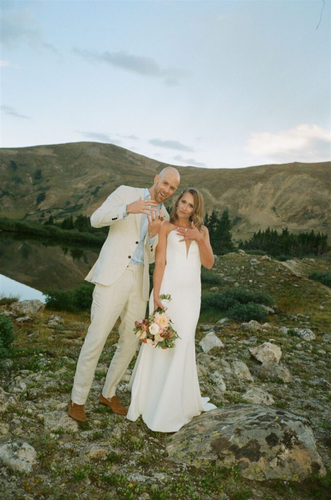 Couple flashes wedding rings during Colorado elopement at Loveland Pass